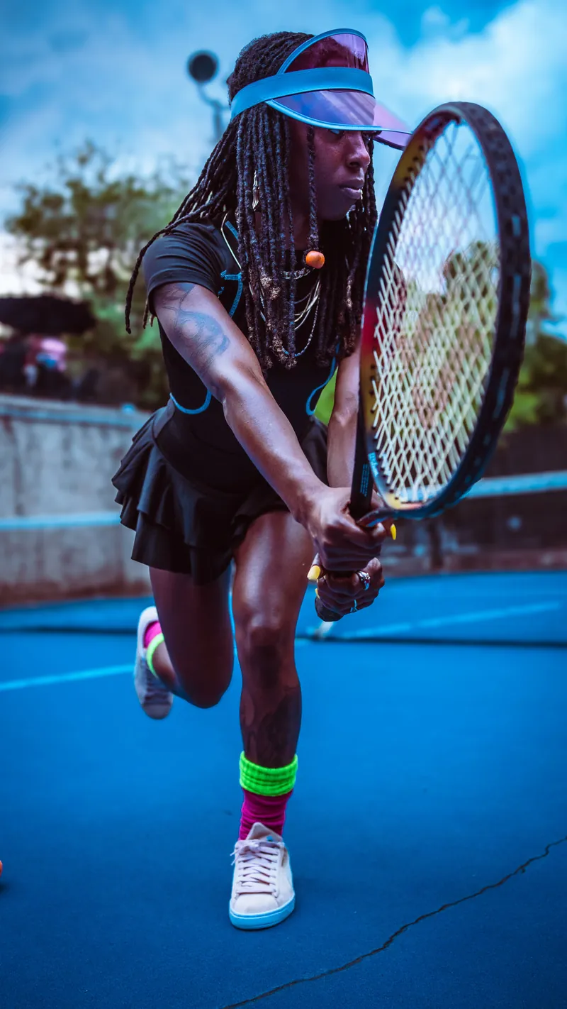 Player hitting a two-handed backhand with a Wilson tennis racket